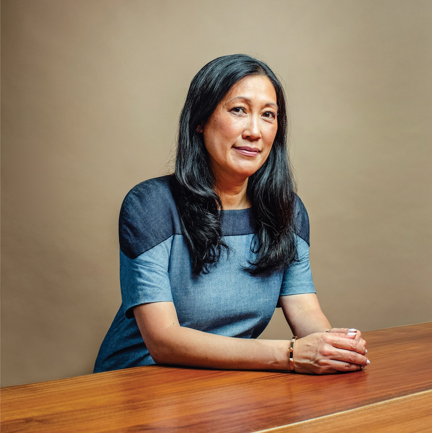 Photograph of ​​​​​​​Theresia Gouw &rsquo;90 at a table